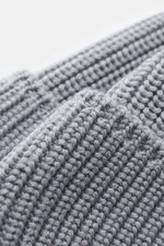 Canada Goose Wool beanie light grey shown in a close-up macro shot from an angled top perspective, highlighting pure wool chunky rib knit fabric and turn-up with woven label. A must-have for colder months: Don’t let bad hair days or cold winter days get t