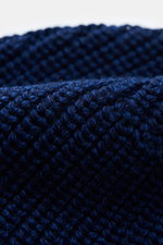 Close-up top view of Canada Goose Wool beanie dark blue showing chunky rib knit pure wool fabric with a turn-up woven label.