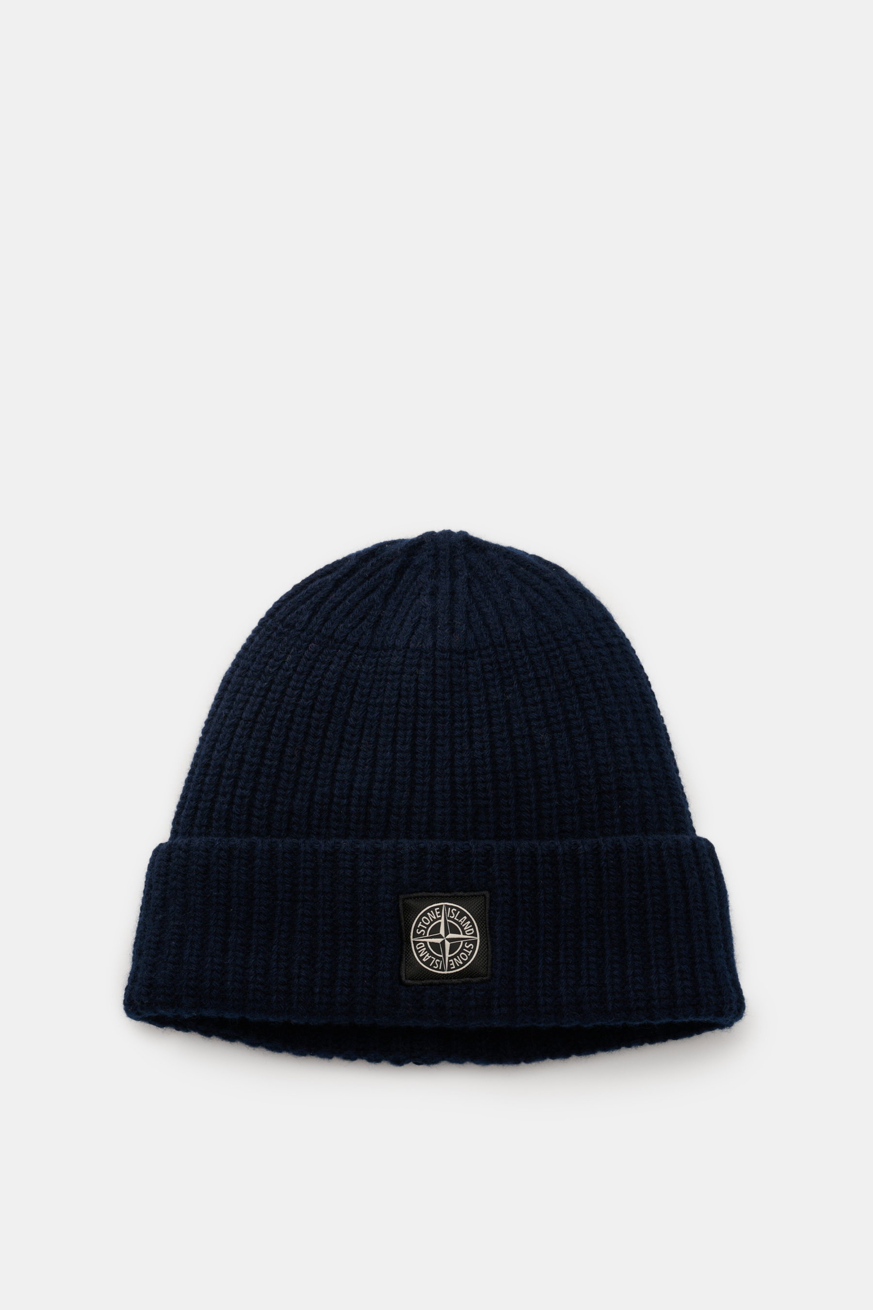Stone Island Wollmütze navy aus reiner Wolle, weicher Griff, moderne Rippstrick-Optik, breiter Umschlag mit Frontlabel, von oben fotografiert.