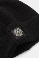 Stone Island Wool Beanie black shown from a close-up side angle, featuring pure wool, soft touch, ribbed knit, wide cuff, and front woven label.