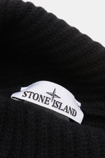 Close-up from above of the Stone Island Wool Beanie black showing soft ribbed knit wool and the white woven label on the wide cuff.