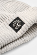 Close-up shot from a slightly angled top view of the Stone Island Light Grey Melange Wool Beanie showing its ribbed knit texture, wide cuff, and black woven label on the front.

<p>Minimalist winter essential: The wool beanie from STONE ISLAND combines fu