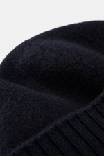 Close-up, top-front perspective of Stone Island Wool beanie navy showing soft pure new wool texture, wide ribbed cuff, and front STONE ISLAND woven label.