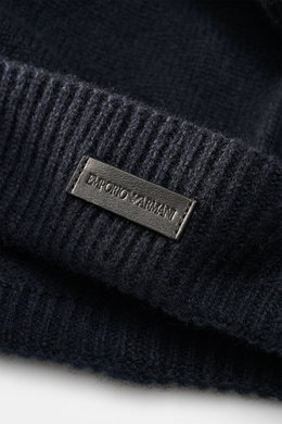 Close-up front-side view of the Emporio Armani Cap navy showing a leather logo patch on the narrow cuff with a fine knit pattern, soft touch, and mix of cashmere and microfiber.