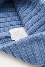 Close-up front-side view of the 04651/ A trip in a bag Cashmere Mütze rauchblau showing soft, medium-knit ribbed texture with label.

<p class="p1">Luxuriöses Winter-Accessoire: Die edle Cashmere-Mütze aus der ‚Look of the Games‘ Capsule von 04651/ A TR