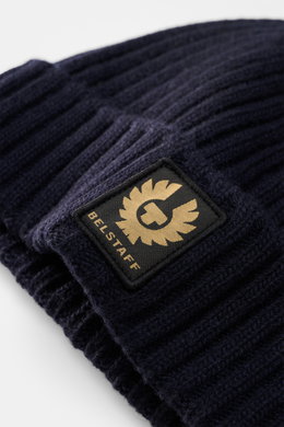 Close-up front view of Belstaff Wool beanie 'Watch' navy in pure wool with soft touch, casual rib knit look, wide turn-up, and woven BELSTAFF label.