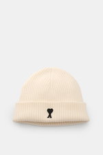 Ami Paris Wool beanie cream photographed from the front, showing pure virgin wool, slightly grippy texture, classic rib knit pattern, wide cuff, and typical logo patch.