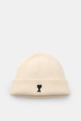 Ami Paris Wool beanie cream photographed from the front, showing pure virgin wool, slightly grippy texture, classic rib knit pattern, wide cuff, and typical logo patch.