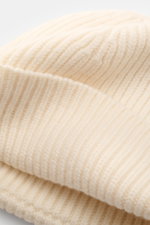 Close-up front-side view of Ami Paris Wool beanie cream in pure virgin wool with slightly grippy texture, classic rib knit pattern, wide cuff, and typical logo patch.