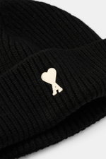 Close-up front angle of Ami Paris Wool beanie black showing pure virgin wool, slightly grippy texture, classic rib knit pattern, wide cuff, and typical logo patch.