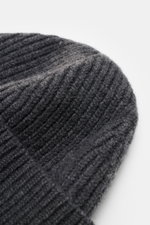 A close-up top-side view of the Ami Paris Beanie Dark Grey showing its heavy rib knit texture, wide cuff, and soft pure virgin wool material with a typical logo patch. Classic with heart: This beanie in heavy knit by AMI PARIS completes your look – for co