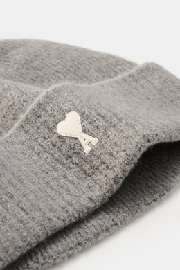 A close-up side view of the Ami Paris Beanie grey showcasing its classic rib knit pattern, wide cuff, and white heart logo patch, made of a soft mix of alpaca, wool, and microfiber for warmth and elasticity.