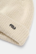 Massimo Osti Studio Beanie sand shown from a close-up front angle, featuring a mix of wool and microfiber, soft feel, classic rib knit pattern, cuff with logo detail.