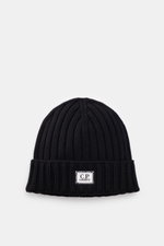 C.P. Company Merino beanie dark navy, top front view, pure merino wool, soft feel, classic ribbed knit pattern, medium coarse knit texture, cuff with logo patch.