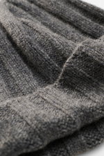 Close-up view of the FTC Cashmere Beanie dark grey showing its ribbed knit pattern, medium-fine knit texture, and narrow cuff with woven label.

<p>Luxurious winter accessory: This ribbed knit beanie is made from finest fair-trade cashmere and is a classi