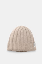 Top-down view of the FTC Cashmere beanie sand, a luxurious rib knit winter accessory in pure, soft Fair Trade cashmere with a medium-fine brioche pattern and a variable brim featuring an FTC woven label.