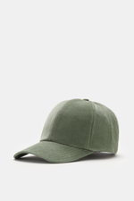 Front-side perspective of 04651/ A trip in a bag Corduroy baseball cap sage, featuring corduroy made of elastic cotton, characteristic texture, classic six-panel design, and adjustable closure.