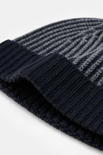 Close-up front-side view of 04651/ A trip in a bag Wool Hat 'Foggy' navy/grey showing pure virgin wool, patent knit, soft touch, medium coarse knit pattern, narrow cuff.