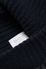 Close-up front angle of 04651/ A trip in a bag Wool Hat 'Foggy' navy/grey showing pure virgin wool, patent knit, soft touch, medium coarse knit pattern, narrow cuff.