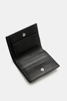 Ami Paris Portemonnaie schwarz, offen von schräg oben fotografiert, fein genarbtes Kalbleder, Münzfach mit Druckknopf, vier Kartensteckfächer.