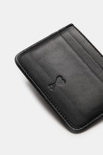 Close-up top view of Ami Paris Card holder black in fine smooth leather with embossed logo and five card slots.

Description: 
<p>Stylish everyday accessory: This card holder by AMI PARIS impresses with timeless design and elegantly and securely stores yo