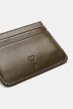 Close-up angled view of Ami Paris Card holder khaki in fine smooth leather with five card slots and embossed logo.

<p>Stylish everyday accessory: This card holder by AMI PARIS impresses with timeless design and keeps your most important cards elegant and