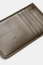 Close-up top view of Ami Paris Card holder khaki in finely grained calf leather showing five card slots, embossed logo, and stitching.

<p>Stylish everyday accessory: This card holder from AMI PARIS impresses with timeless design and keeps your most impor