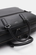 Close-up top-angle view of the Serapian Briefcase black in robust Evoluzione calfskin, showing anthracite hardware, carry handles, and zip compartments.