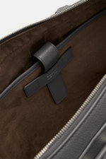 Close-up inside view of the Serapian Briefcase grey showing soft brown textile lining, a grey leather strap, and silver zip teeth from a top perspective. Luxury leather in Italian craftsmanship: This luxurious briefcase from SERAPIAN is made of buttery so