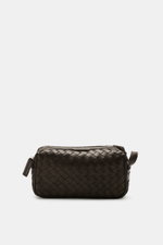 Officine Creative Toiletries bag dark brown shown from the front, featuring plaited leather outer, silver hardware, zippered outside compartment, spacious main compartment, and practical leash, dimensions approx. 25x15x10 cm, a practical travel essential 