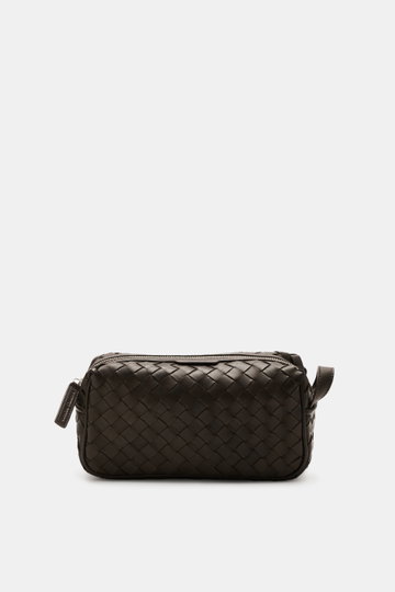 Officine Creative Toiletries bag dark brown shown from the front, featuring plaited leather outer, silver hardware, zippered outside compartment, spacious main compartment, and practical leash, dimensions approx. 25x15x10 cm, a practical travel essential 