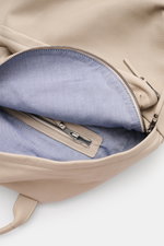 Close-up top-down view of the open 04651/ A trip in a bag Rucksack 'Oyster Back Pack' navy showing soft, textured nubuck leather exterior and smooth blue fabric lining with zipper pocket inside. 

<p>Unkompliziert und stilvoll transportieren Sie Ihre Habs