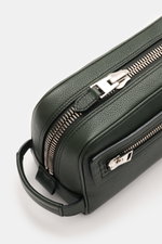 Close-up top-side view of Tom Ford Necessaire dunkelgrün in grained dark green calf leather with silver XL zipper hardware and handle, showing textured surface and zipper details. <p>Dieses edle Necessaire von <span class="hover:entity-accent entity-under