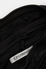 Close-up interior view of the C.P. Company Belt bag black showing zipped compartments and C.P. Company label inside. Don’t go on trips or into the city without this compact, piece-dyed belt bag made of water repellent microfibre by C.P. COMPANY with adjus