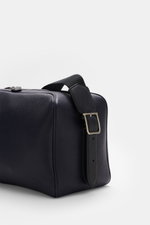 Close-up side view of The Row Crossbody bag 'Jerome' navy in finely grained leather with adjustable strap and embossed logo.

<p> Stylish eye-catcher from THE ROW: The practical crossbody bag impresses with timeless design and becomes the ideal companion 