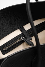 Close-up inside view of The Row Tote bag 'Marlo' black, showing finely grained leather trim, zippered inner pocket, and soft cotton lining from top perspective.

<p> Stylish all-rounder by THE ROW: The practical tote bag impresses with timeless design and