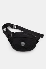 C.P. Company Belt bag black shown from above, compact piece-dyed water repellent microfibre with adjustable strap, zip compartments, lens detail.