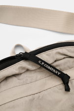 C.P. Company Belt bag grey photographed close-up from above showing zip, black branded pull tab, beige water repellent microfibre strap.