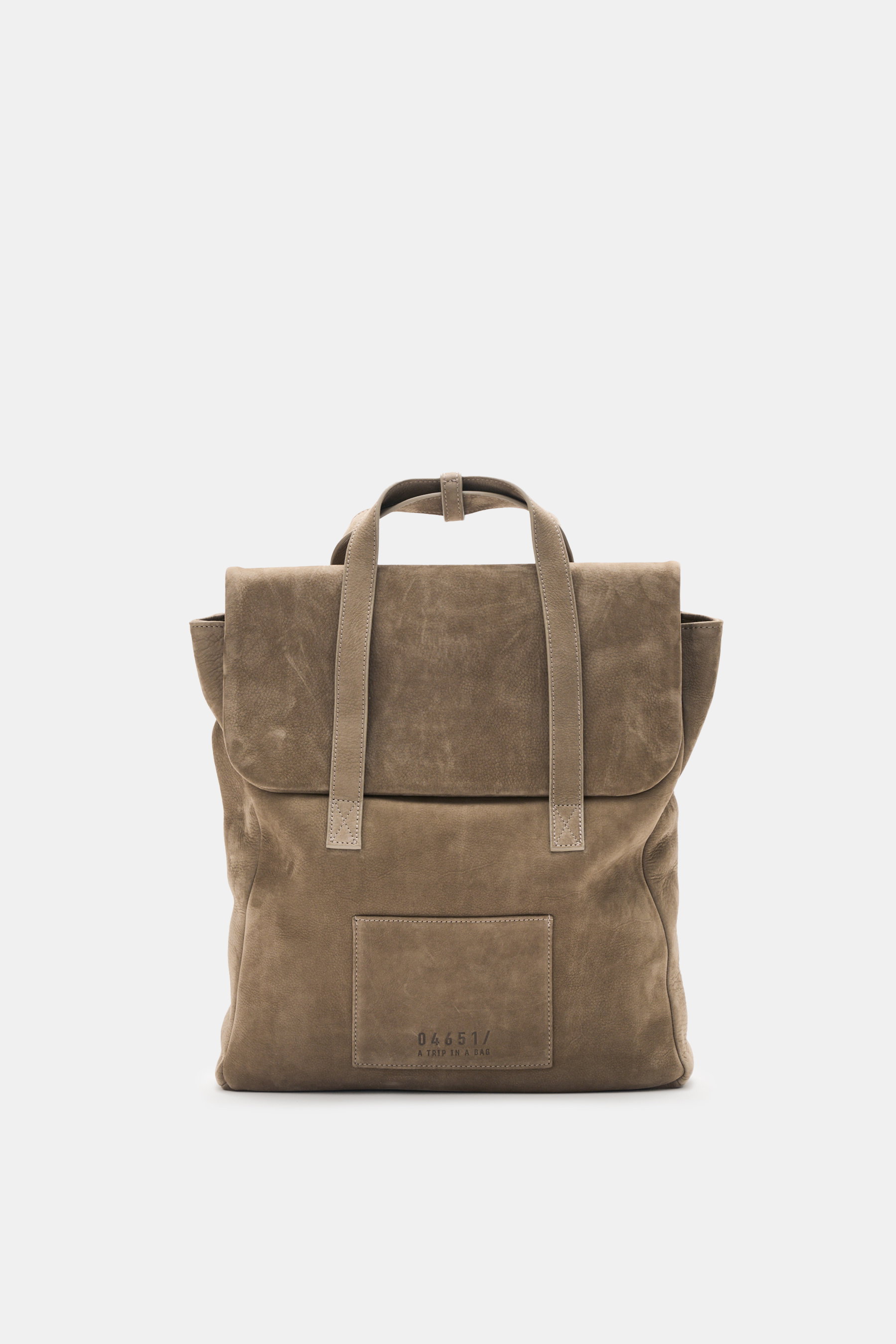 Frontansicht des 04651/ A trip in a bag Rucksack 'Hybrid Tote' taupe aus weichem Nubukleder mit Tragegriffen, Magnetverschluss und Logo-Prägung.