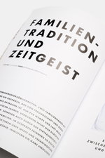 Close-up view of a page from Edition EDITION Magazin Herbst 2025, titled "Familien-Tradition und Zeitgeist," photographed at an angled perspective, reflecting on style as attitude and beauty as language.