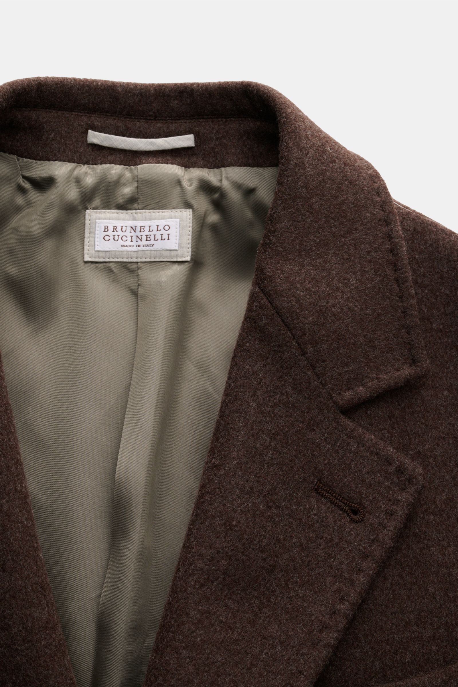 Close-up front view of the Brunello Cucinelli Coat brown showing soft wool fabric, elegant beige lining, and notched lapel with buttonhole. Look forward to the cold weather: The luxurious unconstructed coat by Italian label BRUNELLO CUCINELLI, made of sof