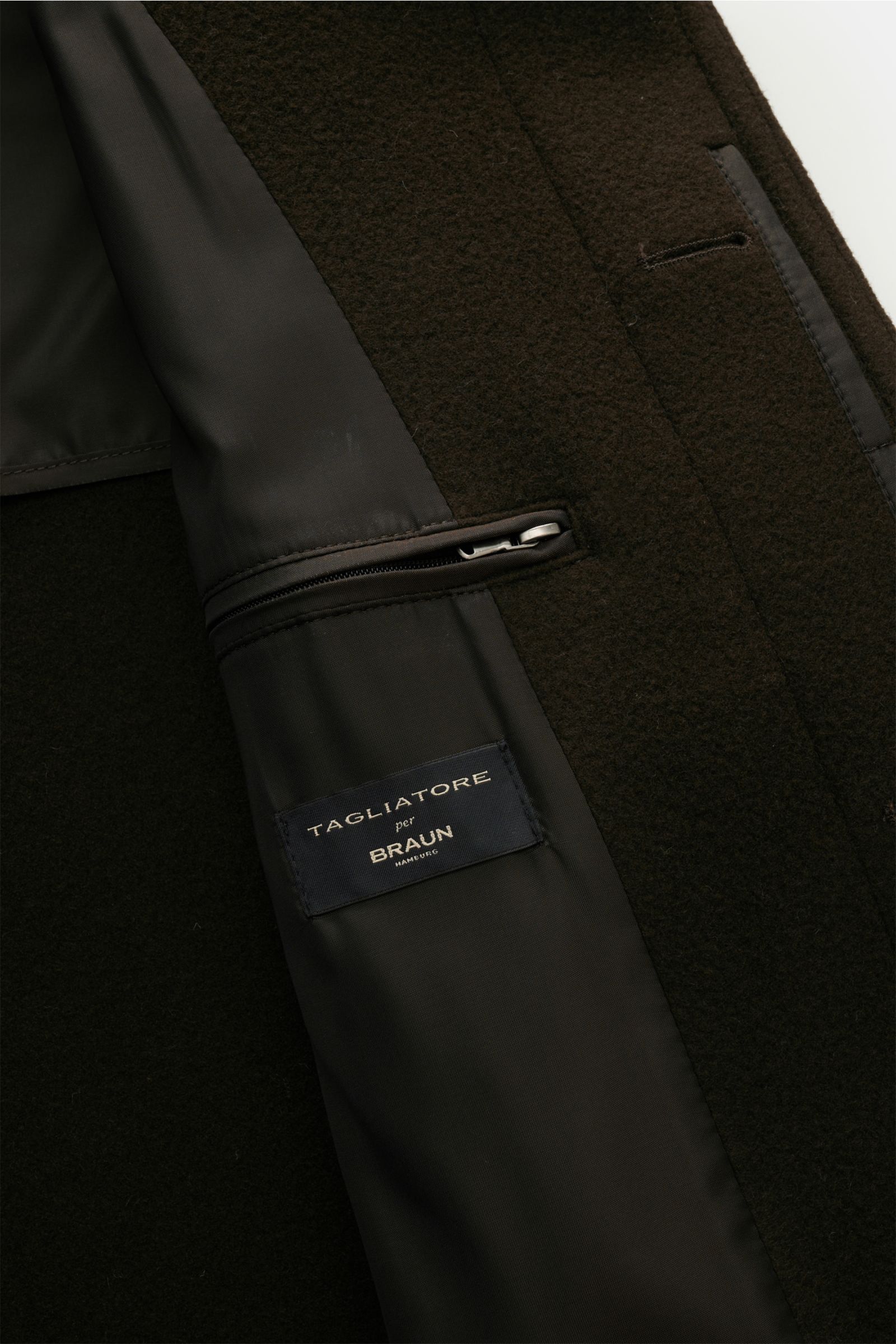 Close-up inside view of the Tagliatore Coat 'Lloyd' dark brown showing the half-lined interior, zipper pocket, and TAGLIATORE per BRAUN label, crafted in pure virgin wool with a slightly textured feel. Stylish classic: This elegant coat in pure virgin woo