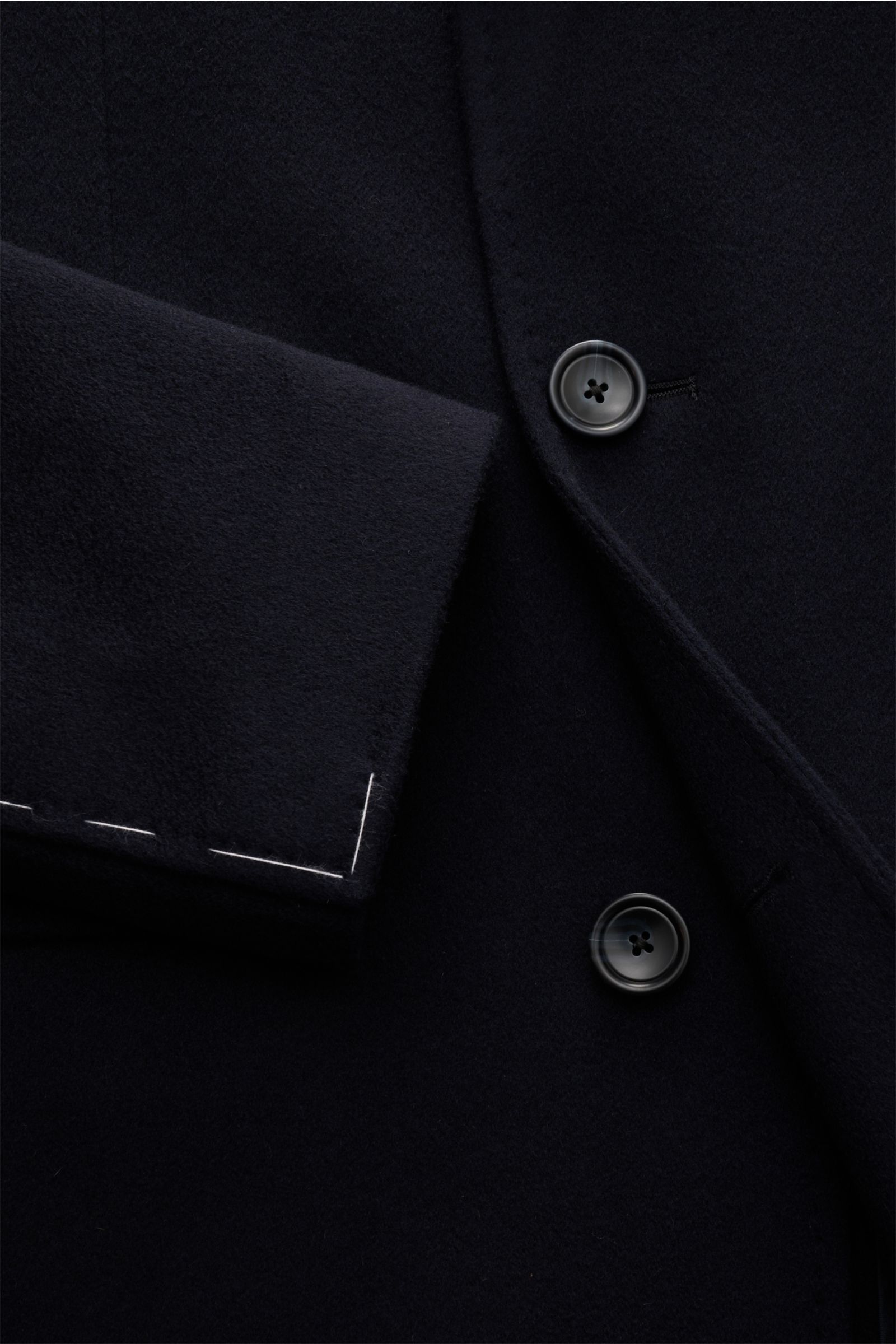 Close-up front view of the Tagliatore Cashmere Mantel navy showing buttons and sleeve detail; pure cashmere, slim fit, three-button front, classic breast pocket, billfold and flap pockets, unfinished sleeve cuffs, center back vent, half-lined with quilted