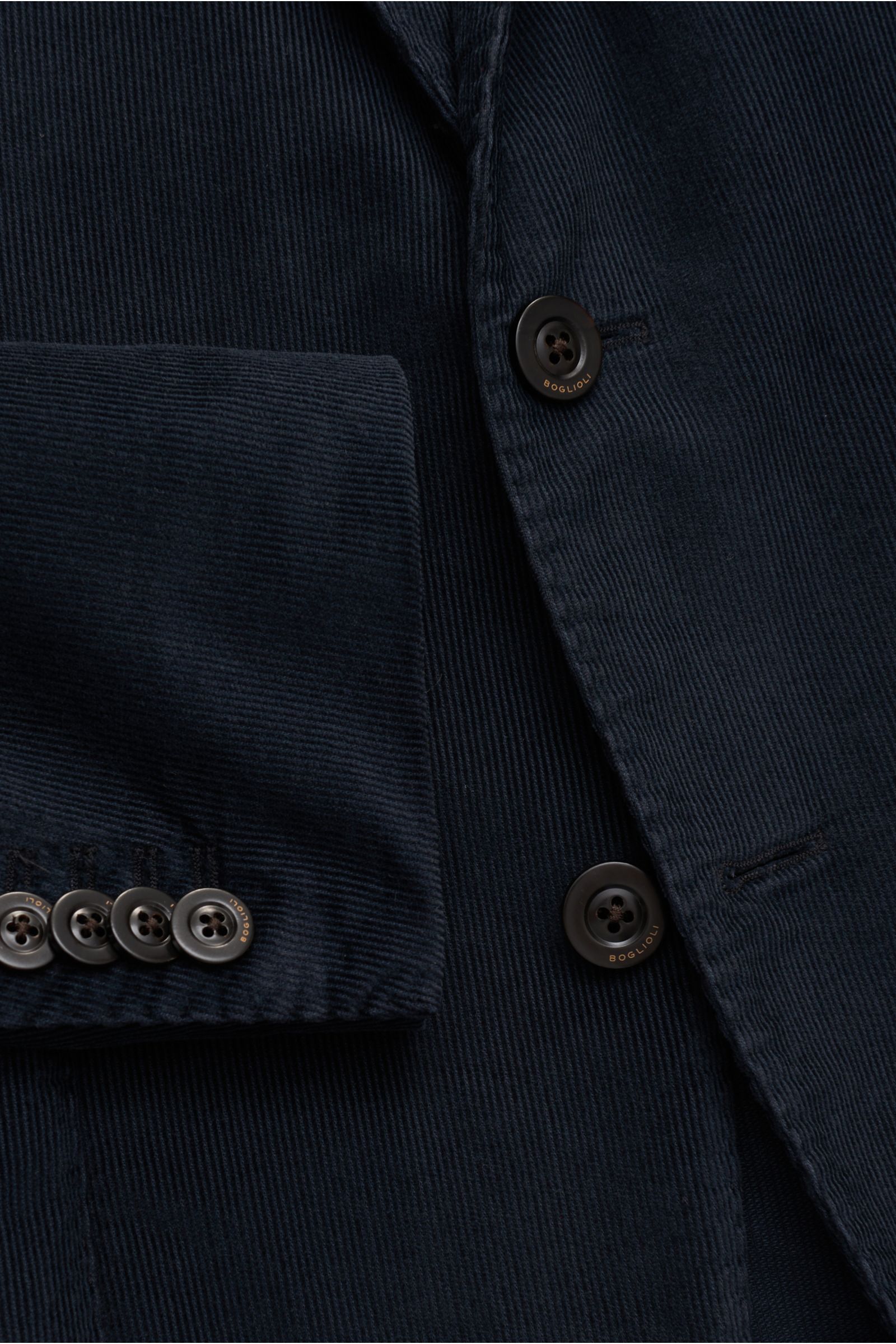 Close-up front view of the navy Boglioli Cord Anzug 'K. Jacket' showing fine cord fabric, buttons with logo, and sleeve cuff details.