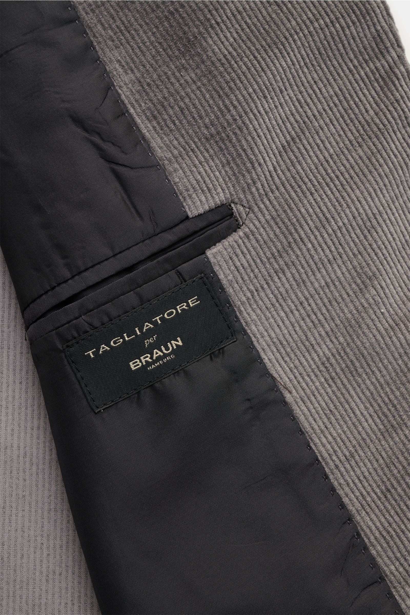 Close-up view of the inside pocket and fabric texture of the Tagliatore Cordanzug beige, featuring a cotton and wool corduroy blend with a soft feel, showcasing the unconstructed slim fit jacket with two buttons, notch lapel with pin, patch hip pockets, a