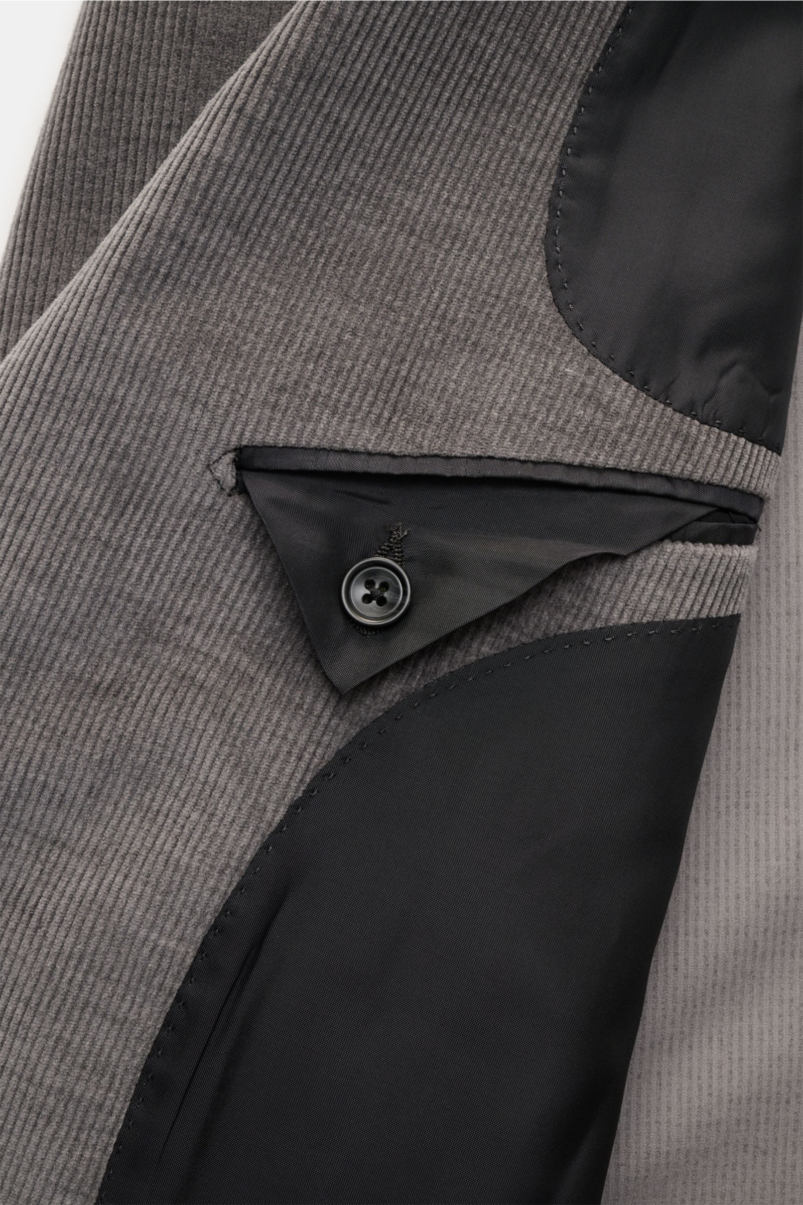Close-up from above of the interior pocket and lining details of the Tagliatore Cordanzug beige, a slim fit, unconstructed cotton and wool corduroy suit with elegant silhouette.