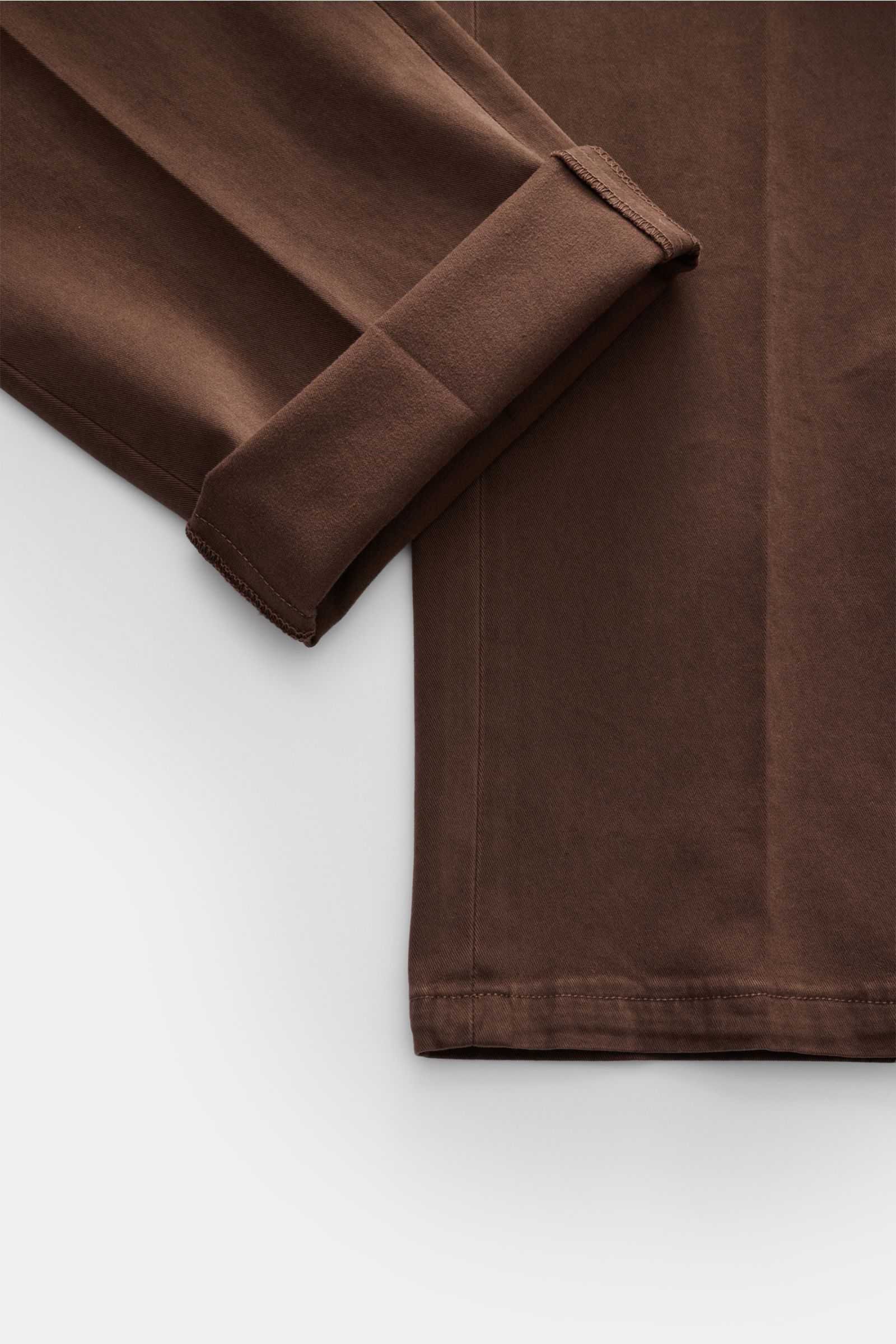 Close-up image of the sleeve and lower section of the Santaniello Anzug taupe, showing soft elastic cotton twill fabric with a smooth finish, photographed from above. Lässigkeit trifft Stil: Dieser Anzug von SANTANIELLO überzeugt mit einem softem Twill au
