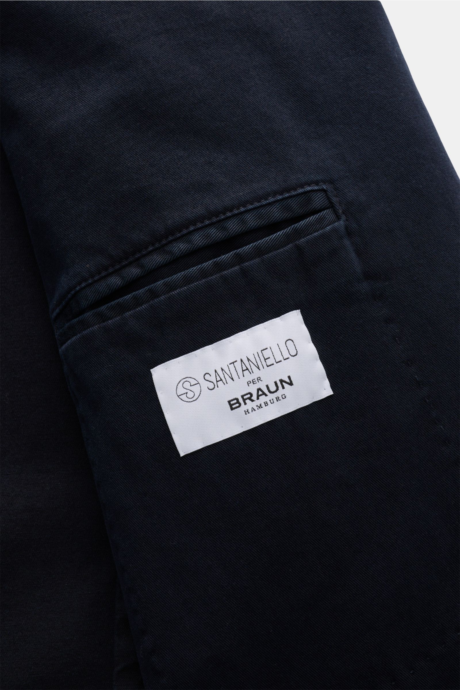 Close-up view of the inner pocket of the Santaniello Anzug grau, showing the Santaniello per Braun Hamburg label on a textured cotton-linen mix fabric. Lässigkeit trifft Stil: Dieser Anzug von SANTANIELLO überzeugt mit einem markant strukturierten Baumwol