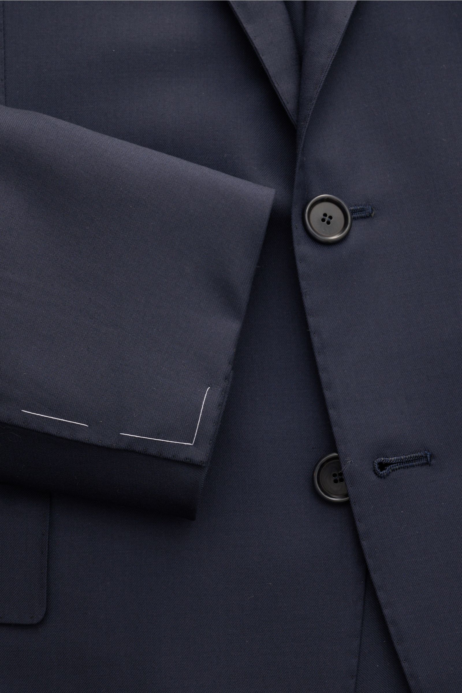 Nahaufnahme des Cesare Attolini Anzugs navy von vorne, zeigt tailliertes Sakko aus Super 150'S Wolle mit Slim Fit und eleganten Knöpfen.