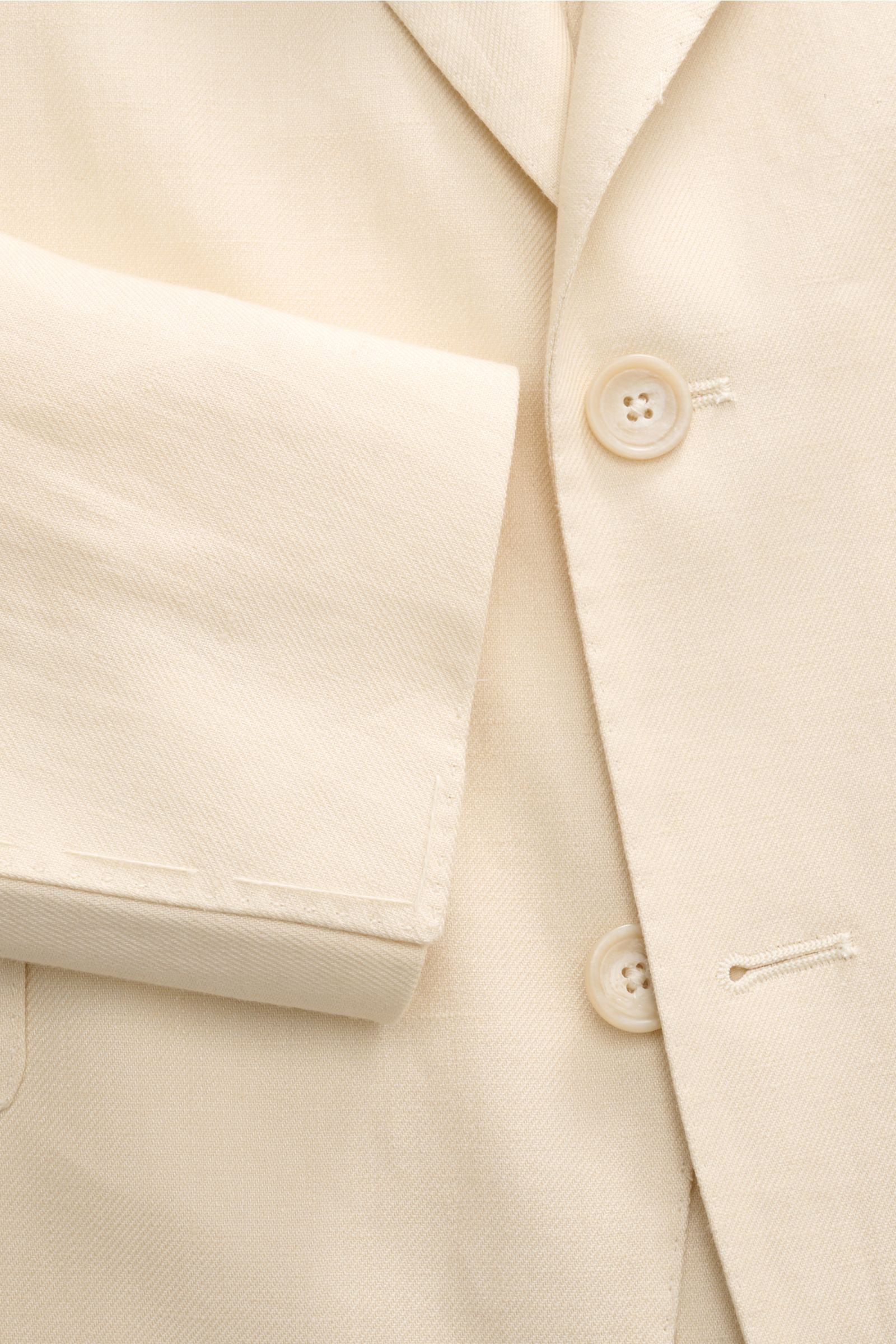 Tagliatore Leinenanzug 'Vesuvio' creme, Nahaufnahme von tailliertem Sakko mit Spitzrevers, Knopf und weichem Leinenstoff, Slim Fit
